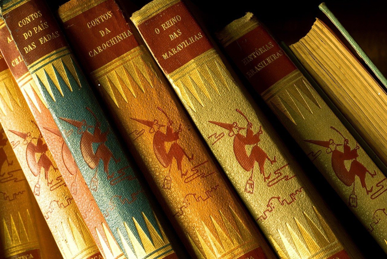 Row of decorated, illustrated book spines on a shelf